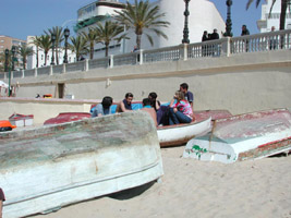 Students take a break between lessons at the city beach, Cadiz
