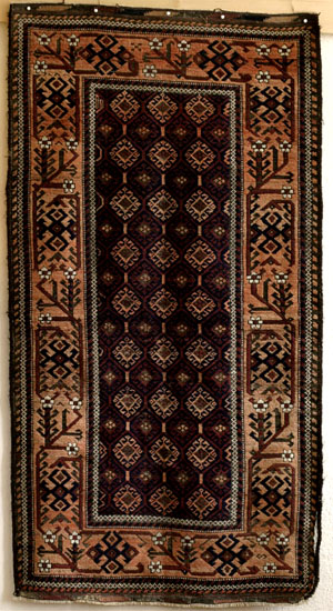 Baluch rug, wide meandering tree border with blossoms