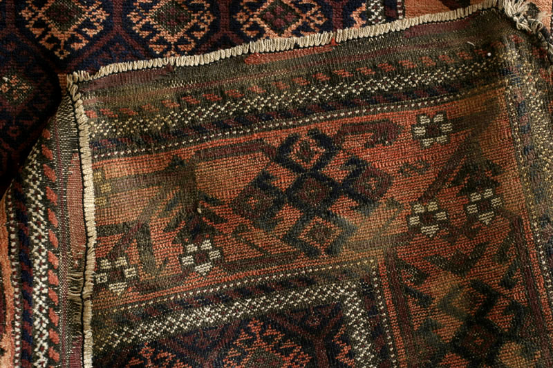 Baluch rug, wide meandering tree border with blossoms, back with glue