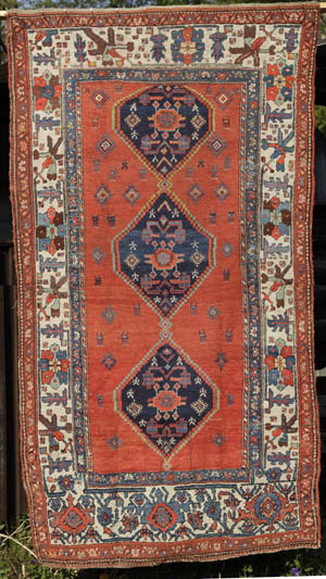 Kurdish medallion rug with humans and animals - opens jpg in same window