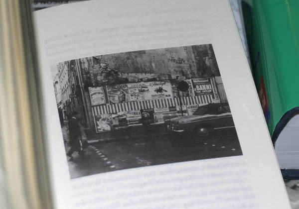 Photo of book showing a photo of a Daniel Buren work featuring stripes